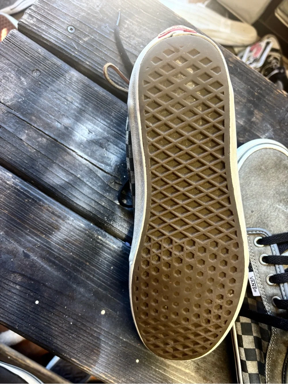 Vans gray suede sneakers with black & white checkerboard pattern on the side
